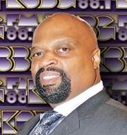 A person in a suit and tie

Description automatically generated